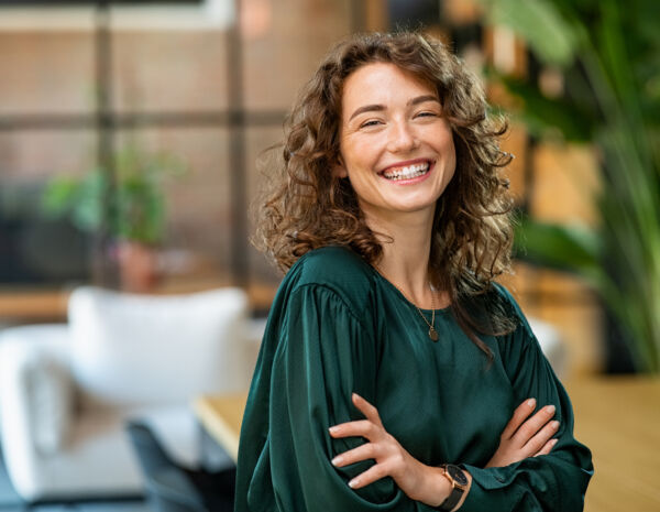 Beautiful woman smiling with crossed arms